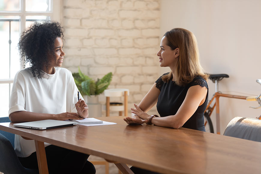 Photo of a woman talking to her boss