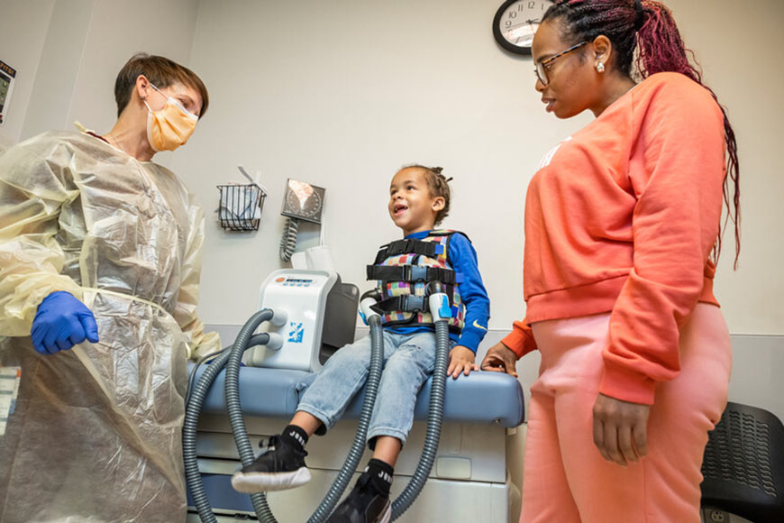 Photo of a woman and her child getting treatment with a doctor