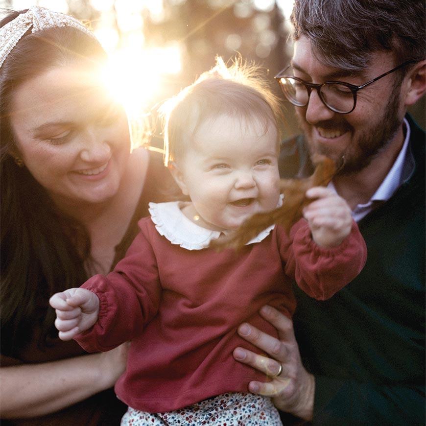 Photo of Martha with her husband and baby